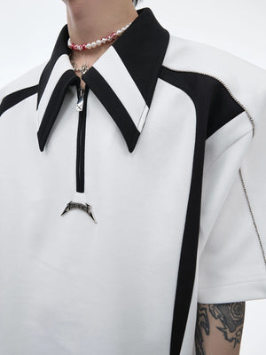 Side view of a black oversized polo showing the structured shoulder silhouette.