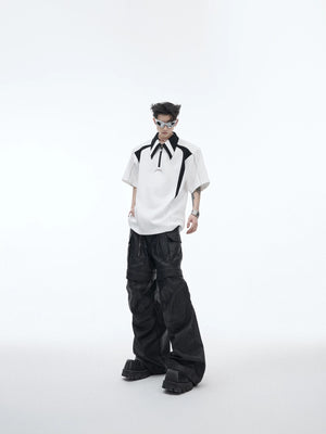 Male model wearing a deconstructed polo with baggy trousers in a city setting.