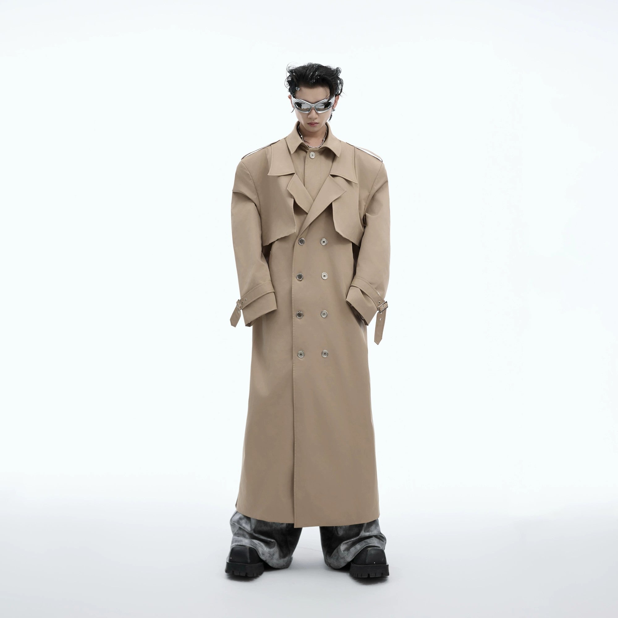 Front view of an oversized deconstructed 2-in-1 streetwear trench coat in black.