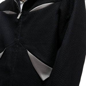 Detail shot of the cropped jacket collar and metallic hardware