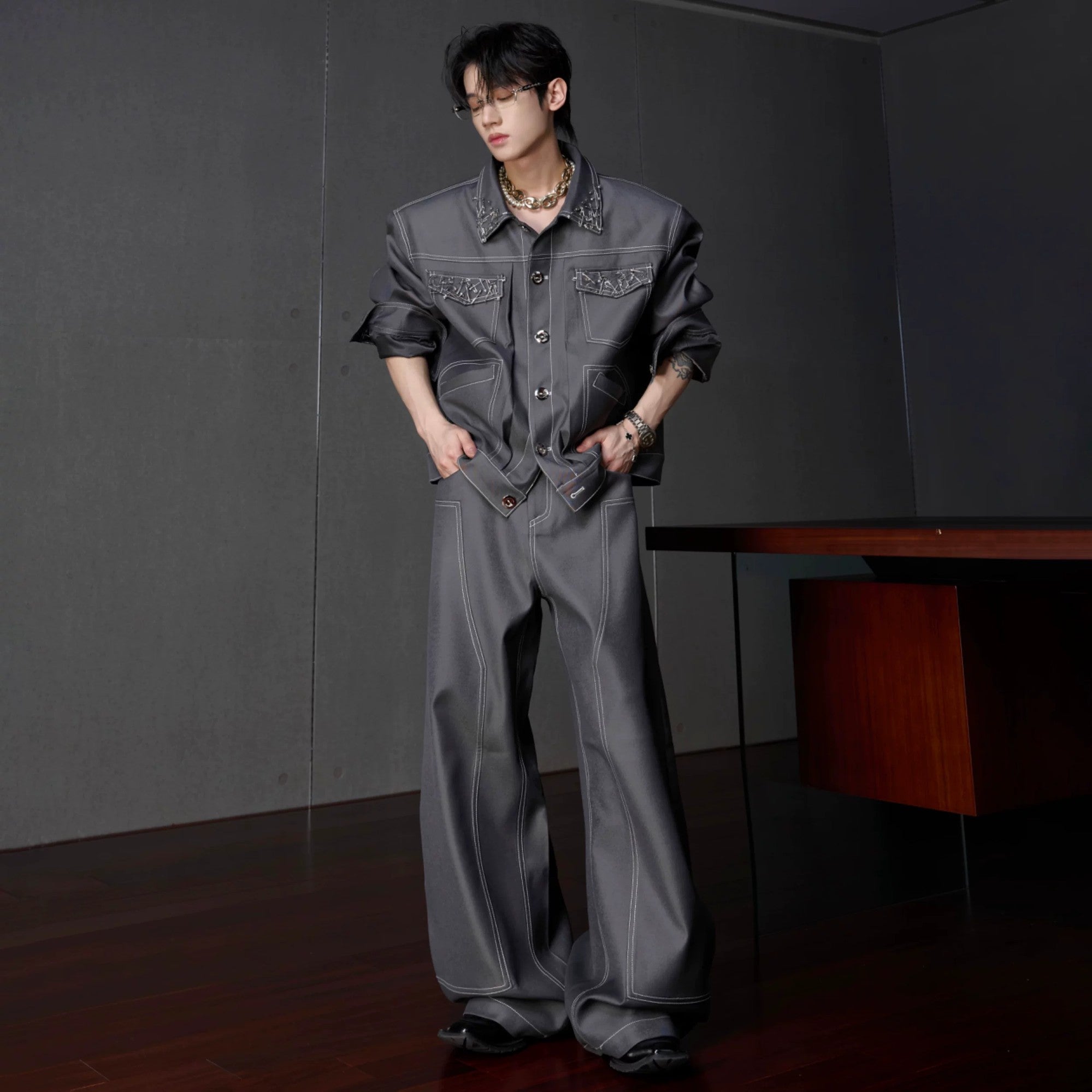 Side view of gray curved scimitar leg pants with 3D asymmetric cut