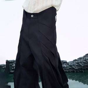 Close up of the unique curved knife pleats and metal buttons