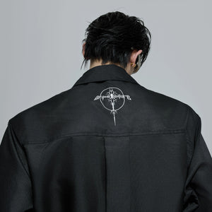 Back view of the red pleated shirt showing loose fit silhouette