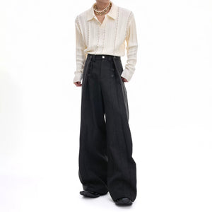 Front view of men's deconstructed pleated straight-leg trousers in black