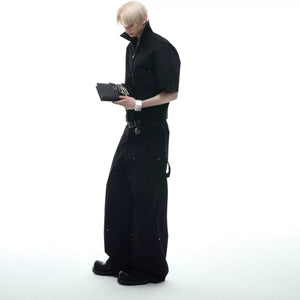 Model wearing black industrial cargo pants with metal hardware