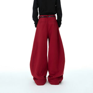 Male model wearing baggy deconstructed pants in an urban street setting