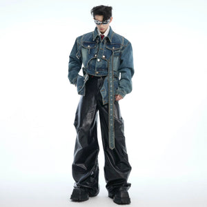 Model wearing a cropped deconstructed denim jacket in black