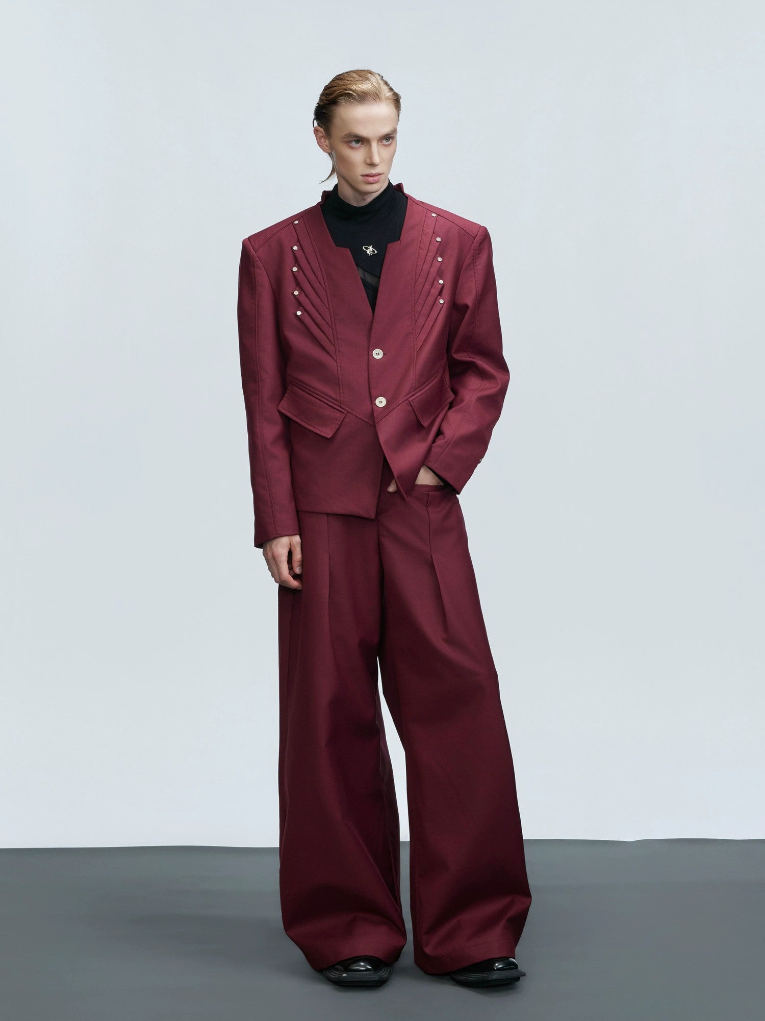 Front view of a red deconstructed wool blazer with 3D tailoring