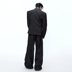 Model wearing the deconstructed suit set in an urban street setting