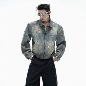 Front view of a blue distressed cropped denim jacket with burnout details