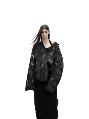 Front view of an oversized black streetwear shirt with white paint splatters