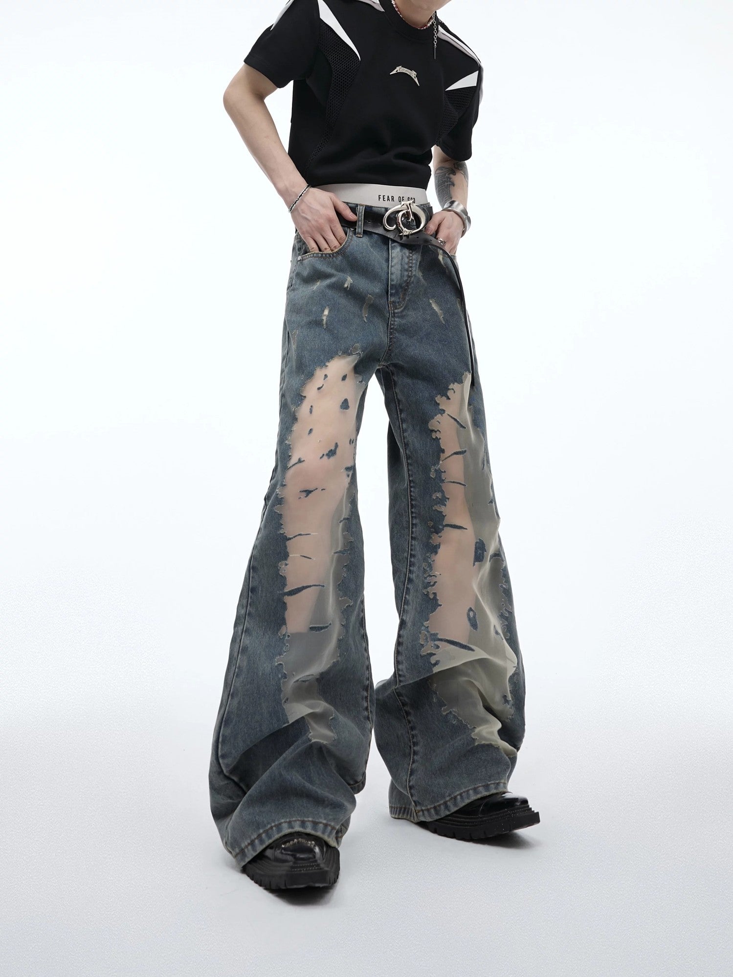 Front view of distressed hollow-out flare jeans in vintage gradient blue