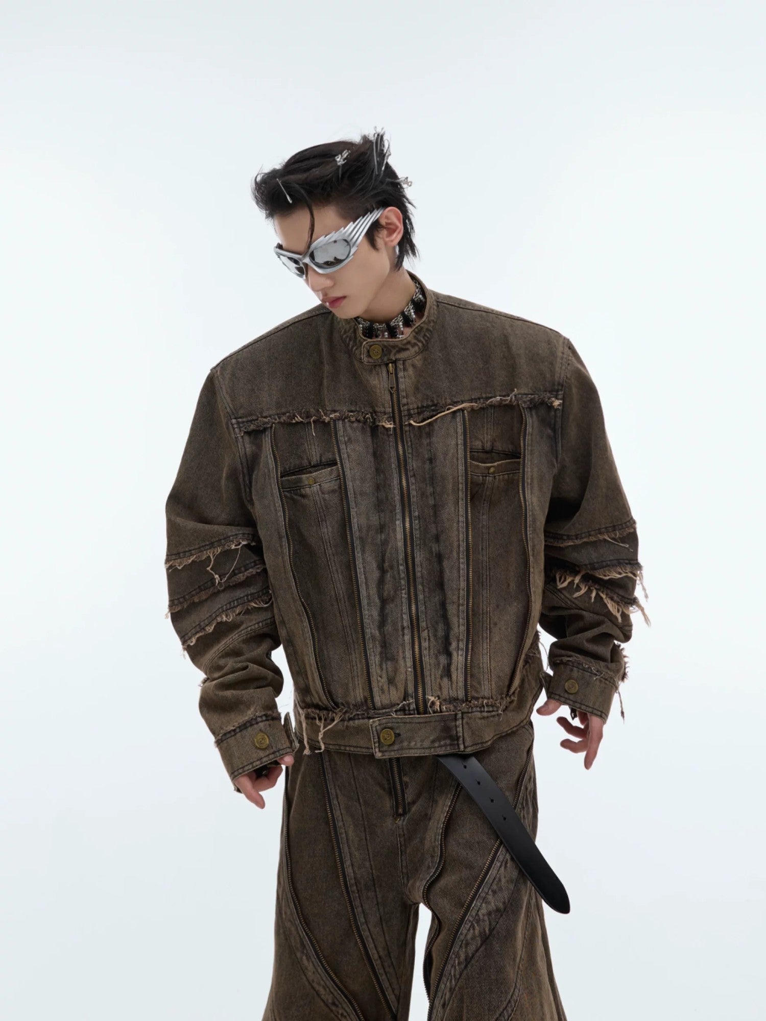 Front view of distressed denim jacket with metal fringe details