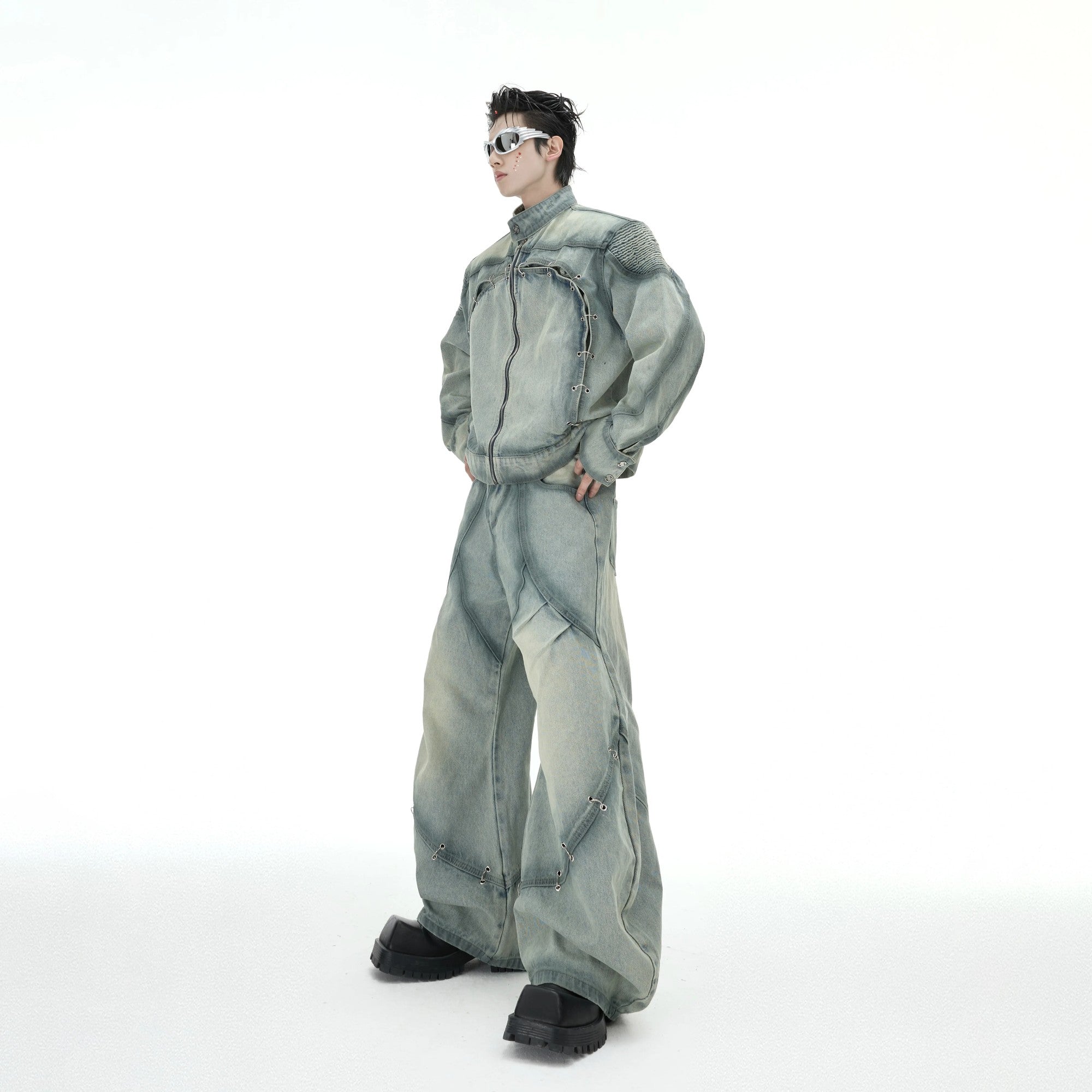 Close-up of the metal ring buckle and irregular wash on the denim jacket