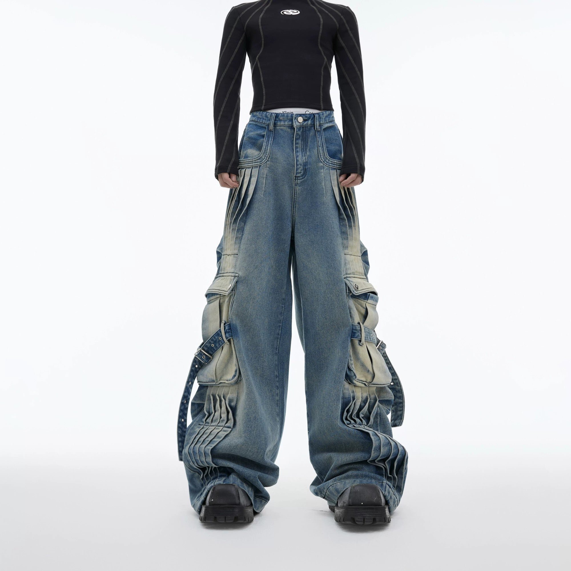Front view of distressed vintage cargo denim pants in blue