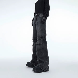 Front view of distressed water ripple washed straight leg jeans