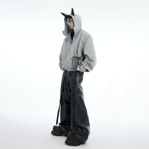 Close up of hand-set metal snake rivets on streetwear hoodie