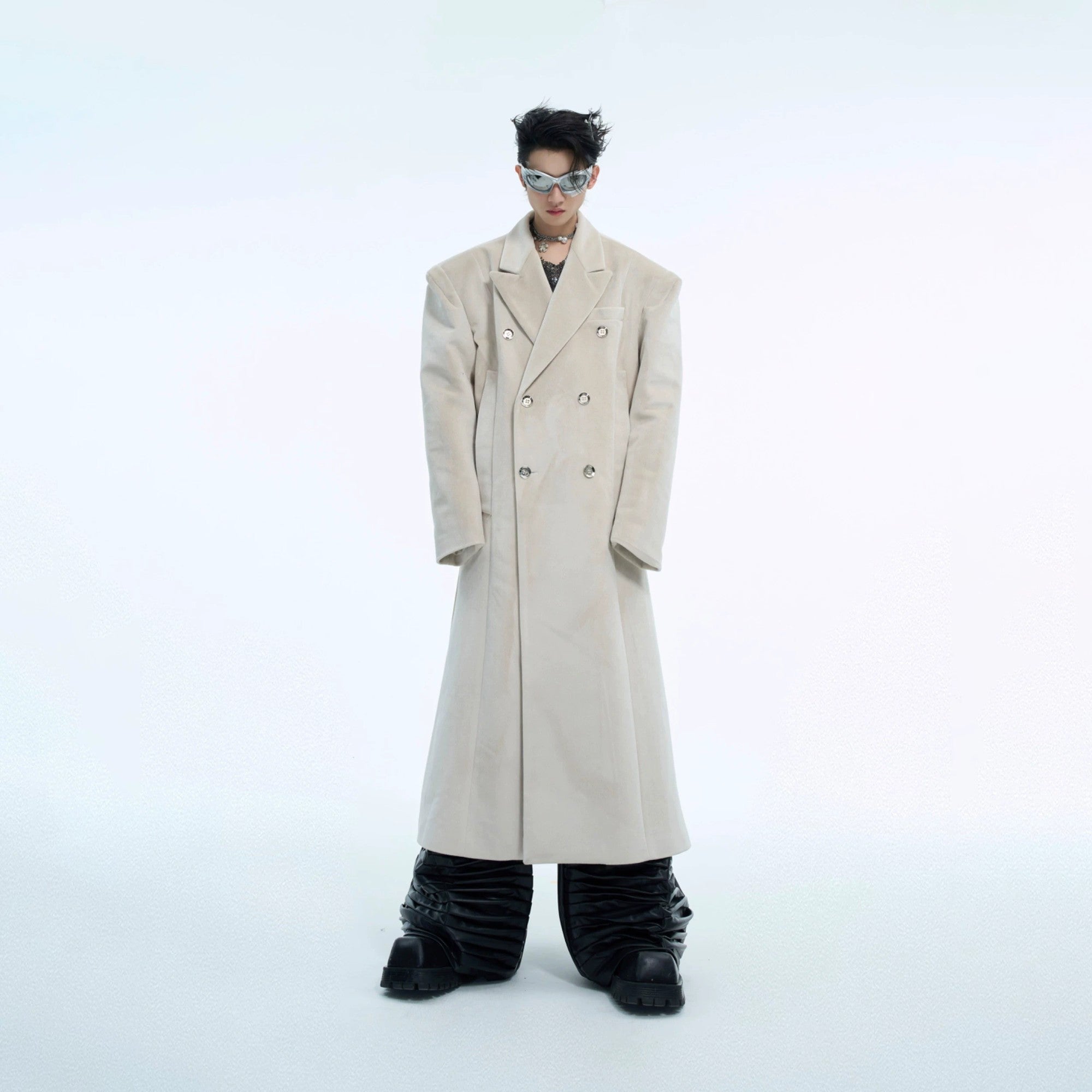 Front view of a man wearing a black oversized double-breasted woolen coat