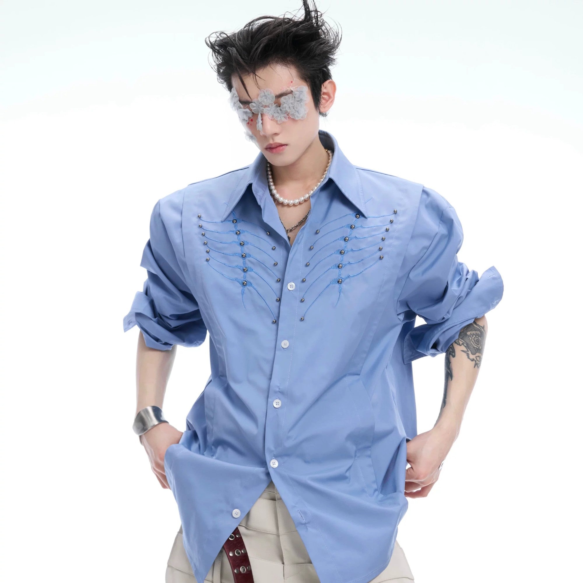 Back view showing intricate spine embroidery on blue casual shirt