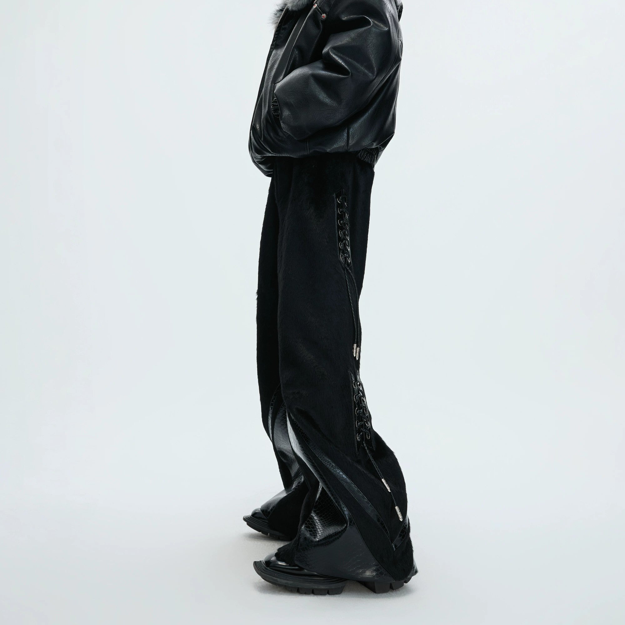 Front view of black deconstructed wide-leg pants with faux pony hair and croc patchwork.