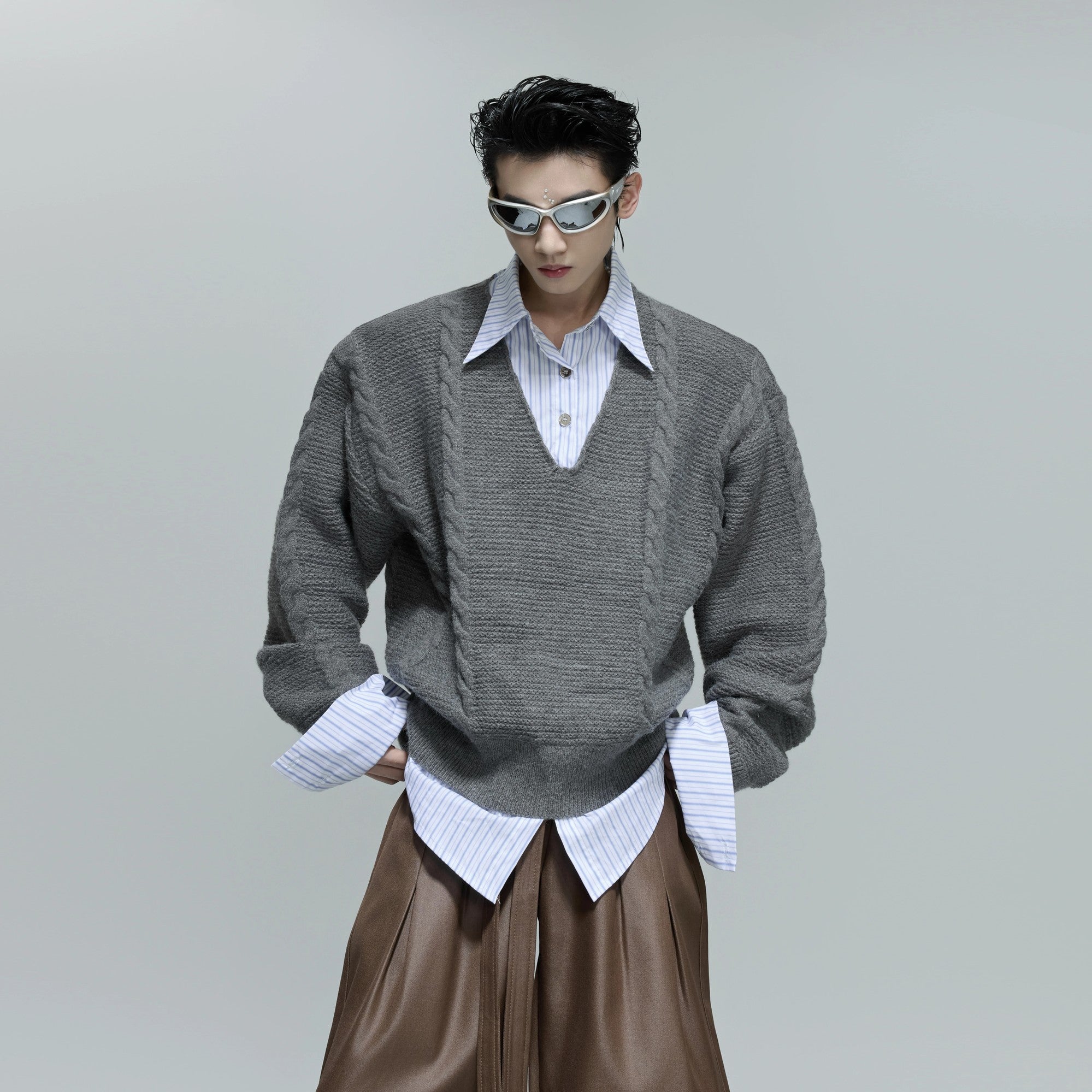 Front view of an oversized gray faux two-piece cable knit sweater