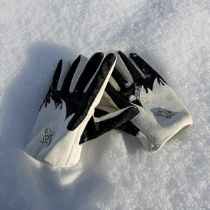 Model wearing flame sheepskin gloves with a black techwear utility jacket