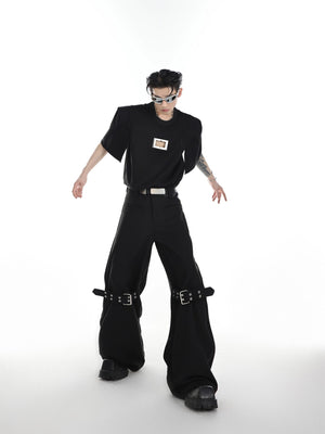 Back view showing the silhouette and fit of the strapped flare trousers.