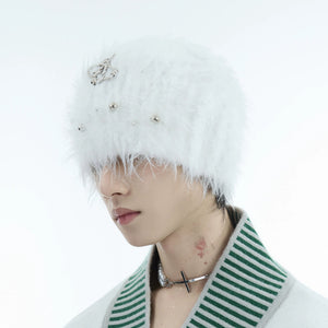 Close-up of metal logo on fuzzy mohair knitted hat