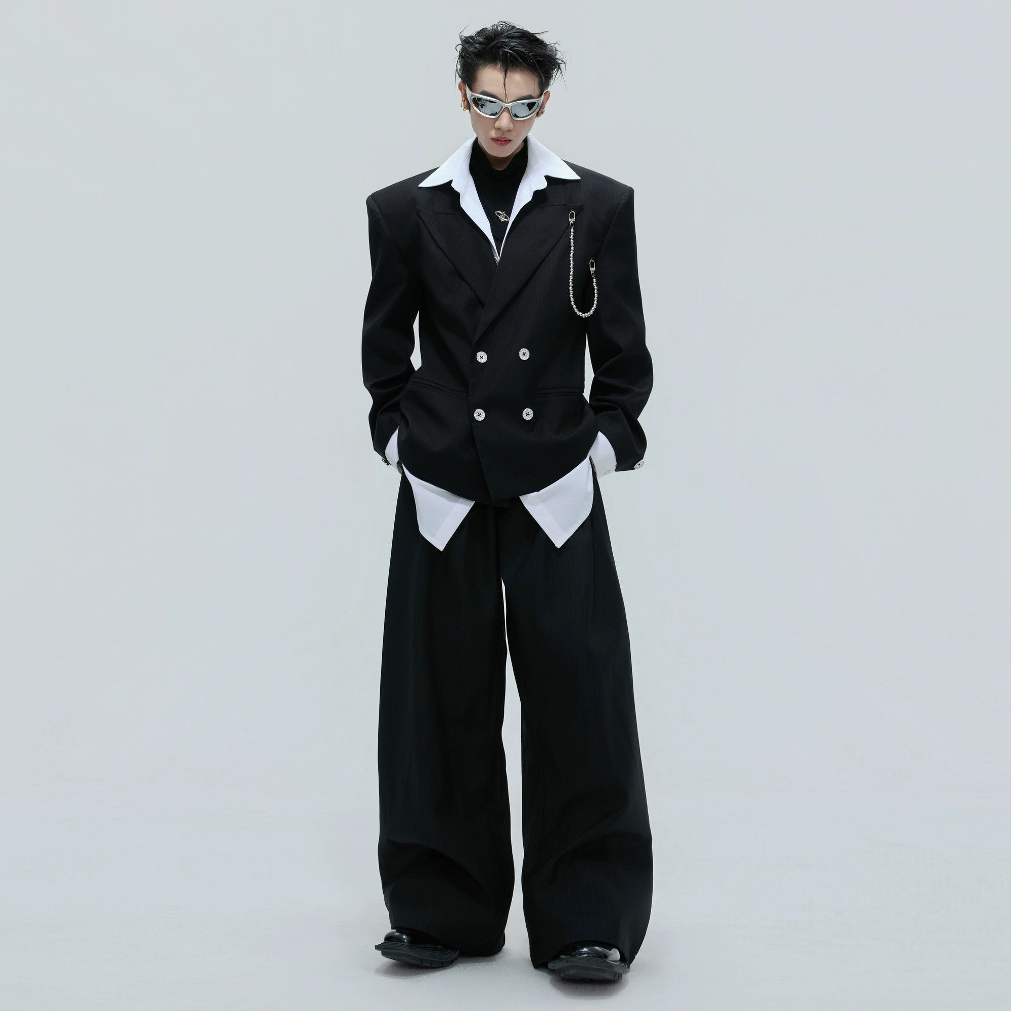 Front view of black glitter stripe cinched blazer with detachable chain