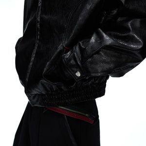 Back view showing the loose fit and deconstructed design of the jacket