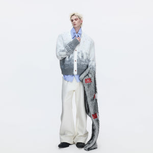 Model wearing oversized gradient cardigan in a winter street setting