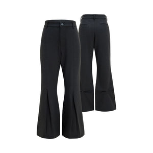 Front view of heavy drape wool pleated flare trousers in black