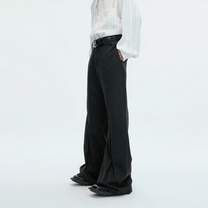 Model wearing micro-flare wool trousers with a relaxed streetwear outfit