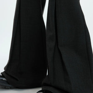 Back view of the power silhouette pleated trousers showing the drape
