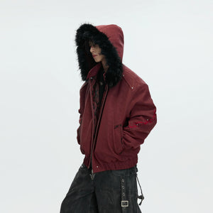 Detailed view of white faux leather jacket showing patchwork and embroidery