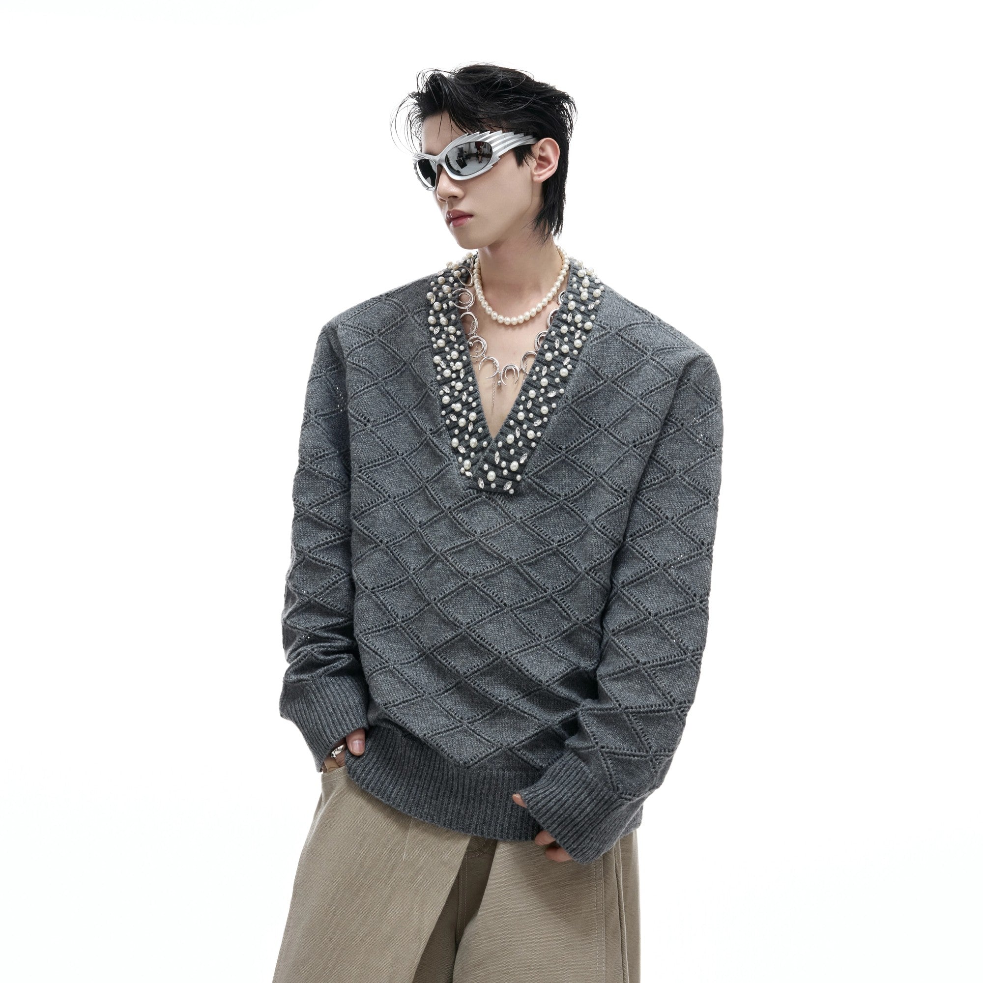 Front view of a heavyweight argyle knit v-neck sweater with rhinestone details