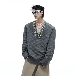 Front view of a heavyweight argyle knit v-neck sweater with rhinestone details