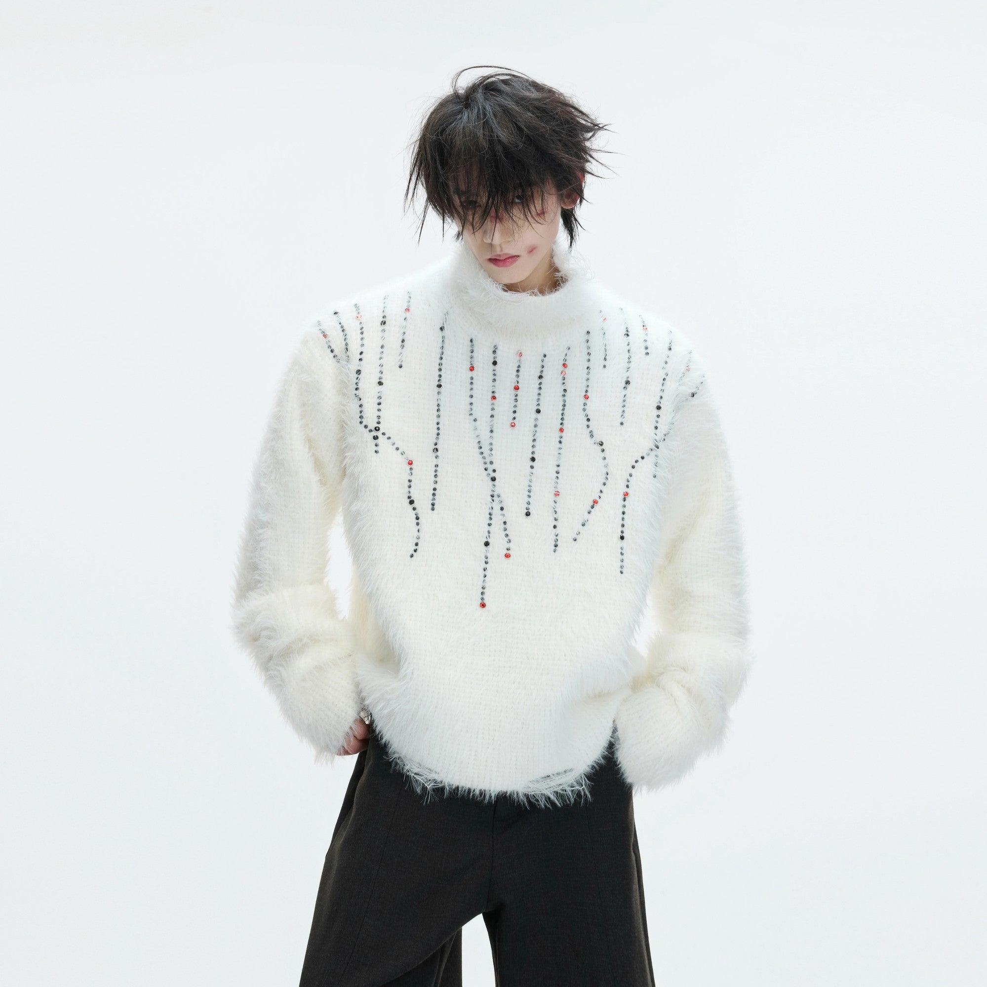 Close-up of a brown heavyweight distressed turtleneck sweater with gem accents