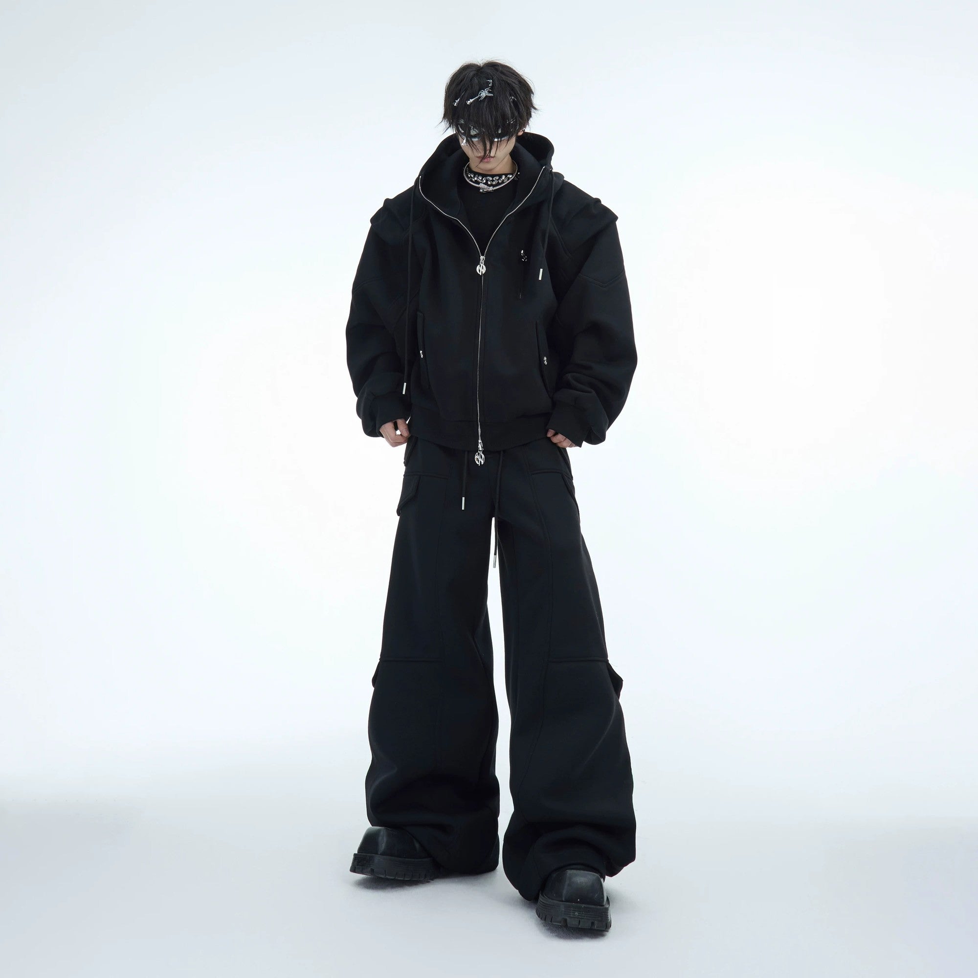 Black 3D pleated streetwear hoodie set styled for urban outdoor