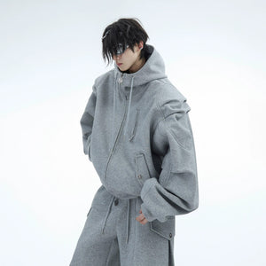 Close-up of the architectural pleats and custom zipper on the hoodie