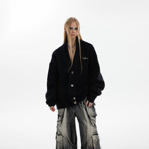 Model wearing a brown oversized ribbed cardigan in an urban setting