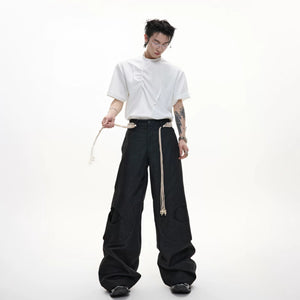 Model wearing deconstructed street style pants with sneakers