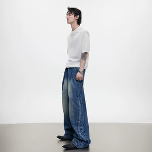 Detail of custom hardware and button fly on blue denim pants