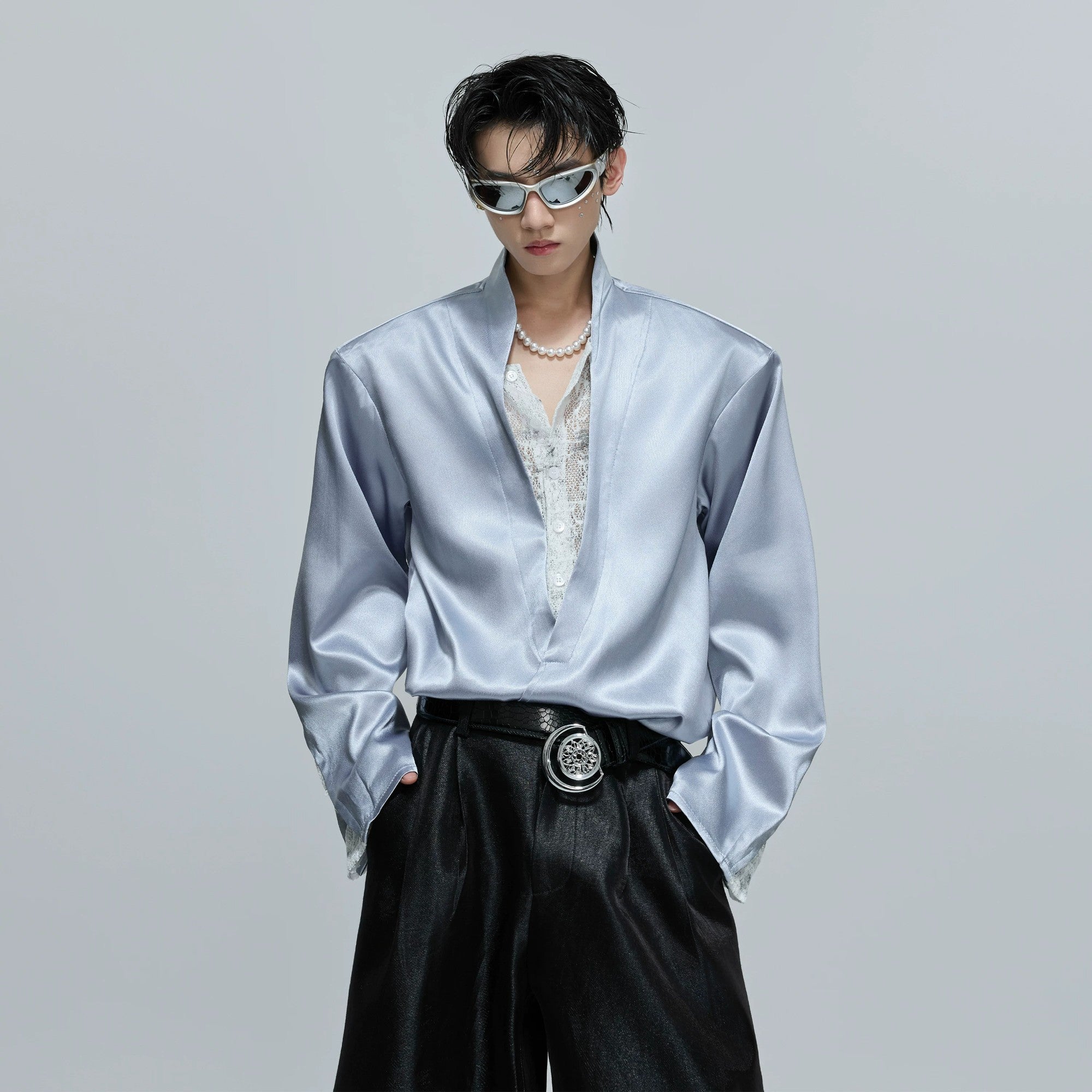 Close-up of the lace and sequin details on a satin streetwear top