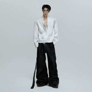 Model wearing a red lace patchwork cropped satin shirt in a street setting