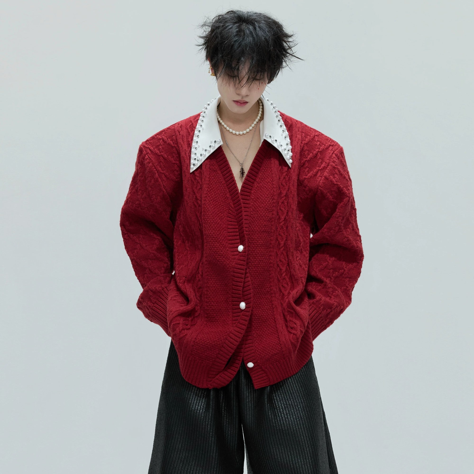 Front view of a luxurious layered wool cardigan with pearl trim collar.