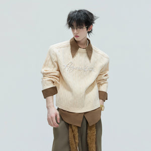 Close-up of hand-finished pearl embellishments on knit fabric