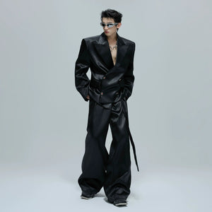 Close up of the cinched waist and button details on a glossy suit jacket