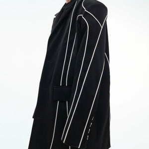Reflective design lines glowing on a black streetwear blazer