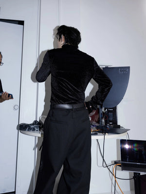 Person walking in a cyberpunk inspired outfit with a metallic stand collar shirt.